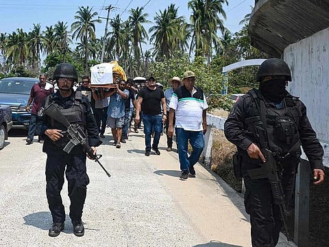 Police officers custody the funeral of mayoral of Lomas candidate of the opposition, Alfredo Cabrera, in Coyuca de Benitez, Guerrero state, Mexico on May 31, 2024.