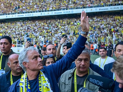 New coach of Turkish club Fenerbahce Jose Mourinho waves during the presentation to the supporters at the Sukru Saracoglu Stadium in Istanbul on Sunday.