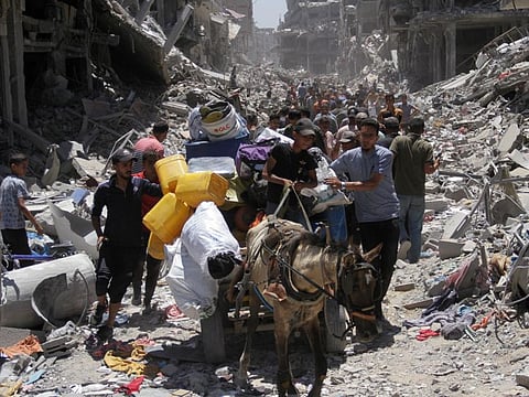 Palestinians make their way, as they inspect the damage after Israeli forces withdrew from Jabalia refugee camp, following a raid, in the northern Gaza Strip, May 31, 2024.