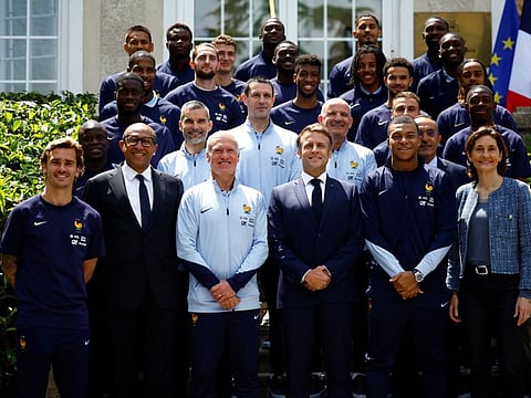 French President Emmanuel Macron, Didier Deschamps, coach of French national football team, French players Kylian Mbappe and Antoine Griezmann, French Football Federation President Philippe Diallo and French Minister for Sports and Olympics Amelie Oudea-Castera pose for a group photo with French national soccer team ahead of the Uefa Euro 2024 at their training camp in Clairefontaine-en-Yvelines, France, on Monday.