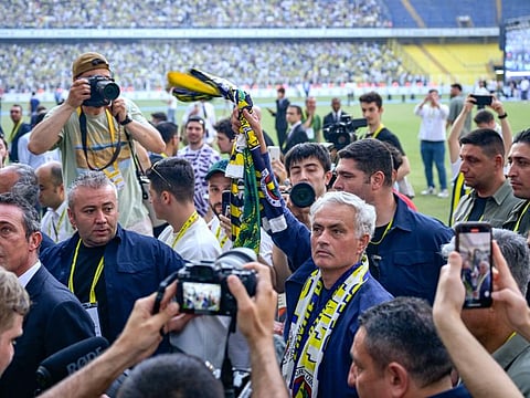 New coach of Turkish club Fenerbahce Jose Mourinho walks in the stadium during the presentation to the supporters at the Sukru Saracoglu Stadium in Istanbul on Sunday.