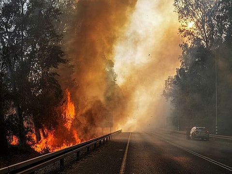 Flames seen at the side of a road, amid ongoing cross-border hostilities between Hezbollah and Israeli forces, close to the Israel border with Lebanon.