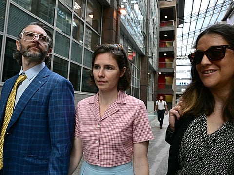 US Amanda Knox (centre) arrives with her husband Christopher Robinson at the courthouse in Florence, on June 5, 2024 before a hearing in a slander case, related to her jailing and later acquittal for the murder of her British roommate in 2007.