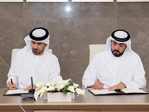 Professor Dr Saif Ghanem Al Suwaidi (L), Director-General of Dubai Courts, and Ahmed bin Masar, Secretary-General of the Supreme Legislation Committee, signing the MoU on Wednesday