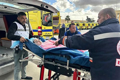 An injured Palestinian child is transferred by Egyptian paramedics into an ambulance, after being allowed to be evacuated from the Gaza Strip via the Rafah crossing on January 14, 2024. By April, between 80,000 and 100,000 Gazans had crossed the Egyptian border, said Diab Allouh, the Palestinian ambassador in Cairo.