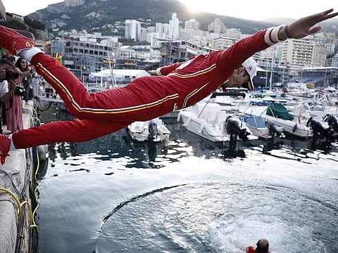 Ferrari's Charles Leclerc dives into the marina after winning the Monaco Grand Prix on May 26.