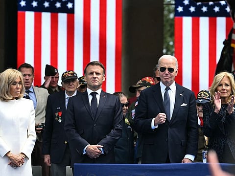 US President Joe Biden (centre), US First Lady Jill Biden (right), France's President Emmanuel Macron and French President's wife Brigitte Macron attend the US ceremony marking the 80th anniversary of the World War II "D-Day" Allied landings in Normandy, at the Normandy American Cemetery and Memorial in Colleville-sur-Mer, which overlooks Omaha Beach in northwestern France, on June 6, 2024.