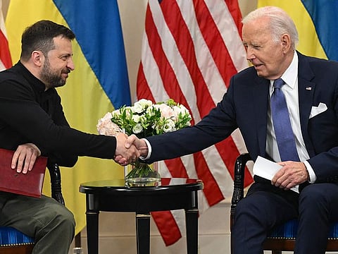 US President Joe Biden (R) shakes hands with Ukraine’s President Volodymyr Zelensky (L) as they hold a bilateral meeting at the Intercontinental Hotel in Paris, on June 7, 2024.