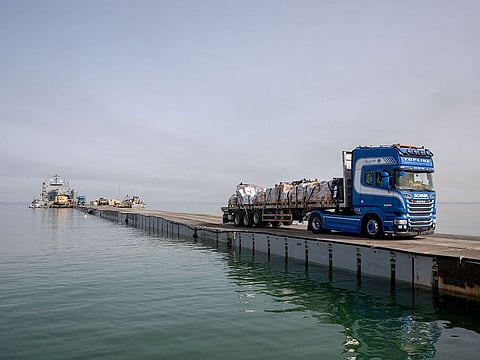 File photo: A truck carries humanitarian aid across Trident Pier, a temporary pier to deliver aid, off the Gaza Strip, near the Gaza coast, on May 19, 2024.