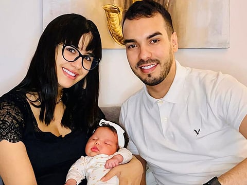 Achraf Amdouni and Dalel Khalfouni with their daughter Melissa.