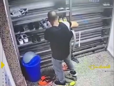 The thief trying out shoe at a mosque in Kuwait.