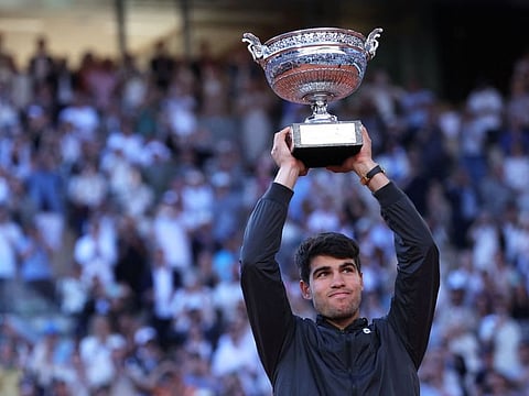 Spain's Carlos Alcaraz raises the trophy after winning against Germany's Alexander Zverev in the men's singles final match on Court Philippe-Chatrier at the Roland Garros Complex in Paris on Sunday.