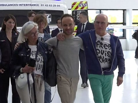 French citizen Louis Arnaud flanked by his mother and father upon arrival at Le Bourget airport.