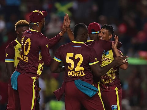 West Indies players celebrate a wicket during the Group C match against New Zealand in Trinidad on Wednesday.