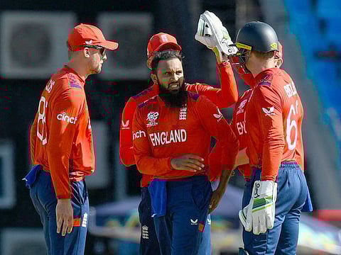 Adil Rashid (centre) of England celebrates the dismissal of Mehran Khan of Oman during the ICC Men’s T20 Cricket World Cup group B match at Vivian Richards Cricket Stadium in North Sound, Antigua and Barbuda, on June 13, 2024.