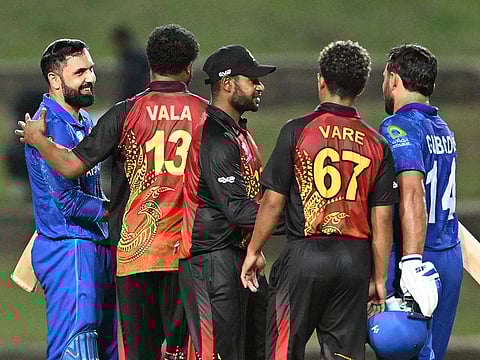 Papua New Guinea's players congratulate Afghanistan's Gulbadin Naib and Mohammad Nabi after Afghanistan won the ICC men's Twenty20 Cricket World Cup 2024 group C cricket match at Brian Lara Cricket Academy Stadium in Tarouba, Trinidad and Tobago, June 13, 2024.