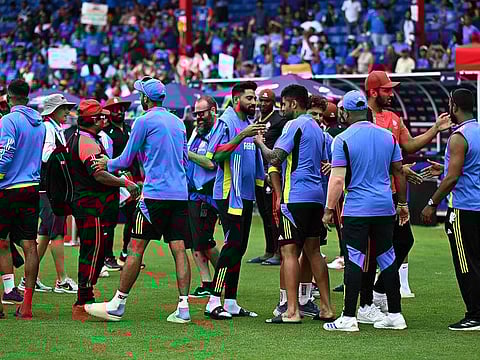 India and Canada team members shake hands after their ICC men's Twenty20 World Cup 2024 group A cricket match was abandoned at Central Broward Park & Broward County Stadium in Lauderhill, Florida on June 15, 2024.