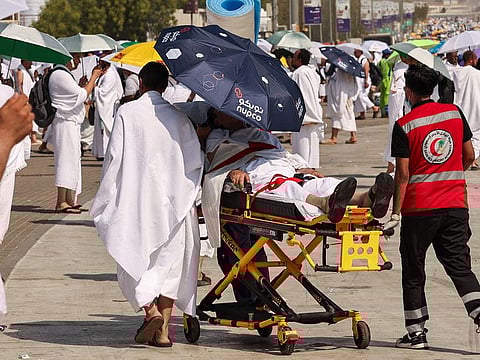 Medics tend to a man who had a heat stroke as pilgrims make their way towards Saudi Arabia's Mount Arafat on June15, 2024..