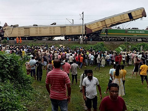 People look on at the site of a collision between an express passenger train and a goods train in Nirmaljote, near Rangapani station in India's West Bangal state.
