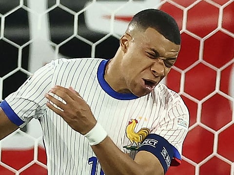 France's forward Kylian Mbappe reacts after being injured during the UEFA Euro 2024 Group D football match against Austria at the Duesseldorf Arena in Duesseldorf on June 17, 2024.