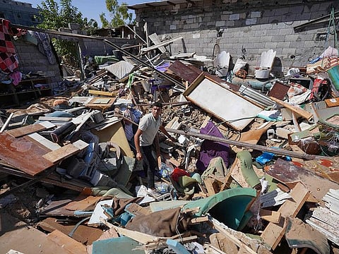 A Palestinian man searches the rubble of the al-Madhoun family home following overnight Israeli strikes in the Nuseirat refugee camp in the central Gaza Strip, on June 18, 2024, amid the ongoing conflict between Israel and the Palestinian militant Hamas movement