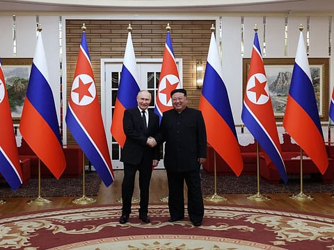 TOPSHOT - In this pool photograph distributed by the Russian state agency Sputnik, Russia's President Vladimir Putin (L) shakes hands with North Korea's leader Kim Jong Un during a meeting in Pyongyang on June 19, 2024. Putin enjoyed a red carpet welcome, a military ceremony and an embrace from North Korea's Kim Jong Un during a state visit to Pyongyang where they both pledged to forge closer ties. (Photo by Gavriil GRIGOROV / POOL / AFP) / -- Editor's note : this image is distributed by the Russian state owned agency Sputnik --