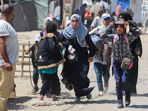 Palestinians run during Israeli bombardment in Rafah in the southern Gaza Strip on June 19, 2024.