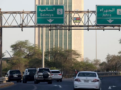 Cars drive past Kuwait's main governmental electricity control tower where a thermometer placed on the building reads 47 degrees Celsius (116 Fahrenheit) at 17:53, in Kuwait City on June 19, 2024.