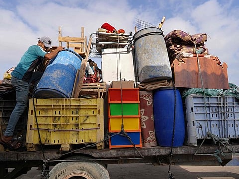A man loads a truck as displaced Palestinians leave Rafah towards Khan Younis on June 20, 2024.