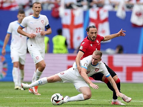 Czech Republic's midfielder #08 Petr Sevcik (C) fights for the ball with Georgia's midfielder #06 Giorgi Kochorashvili during the UEFA Euro 2024 Group F football match between Georgia and the Czech Republic at the Volksparkstadion in Hamburg on June 22, 2024.