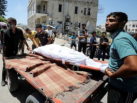 People carry the body of a Palestinian killed in Israeli strikes in Gaza City, on June 21, 2024.