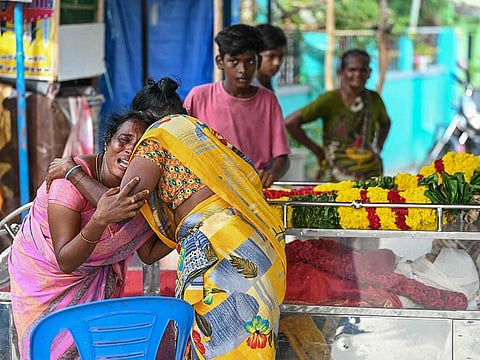 Family members weep next to the dead body of a victim who died after consuming toxic alcohol in Kallakurichi district of India's Tamil Nadu state.