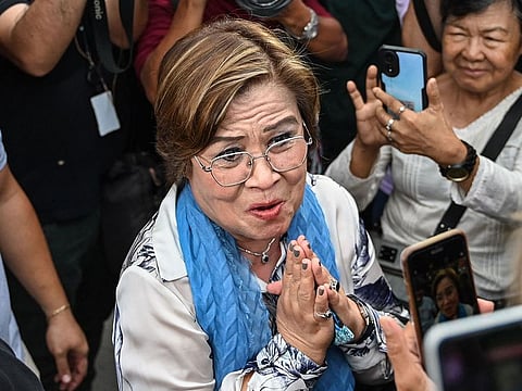 Former Philippine senator and human rights campaigner Leila de Lima acknowledges supporters after all remaining criminal charges against her were dropped, outside a court in Muntinlupa.
