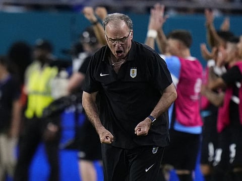 Marcelo Bielsa, head coach of Uruguay, celebrates the team's third goal scored.