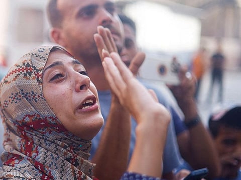 A Palestinian mother says goodbye to her son who is a patient, before he is transferred for treatment abroad through the Kerem Shalom crossing, amid the Israel-Hamas conflict, in Khan Younis in the southern Gaza Strip June 27, 2024.