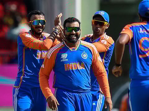 Axar Patel (left), who was adjudged the player of the match, celebrates his wicket with Suryakumar Yadav (right) and skipper Rohit Sharma during the semi-finals against England.