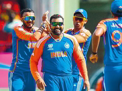 Axar Patel (left), Suryakumar Yadav (right) and Rohit Sharma of India celebrate during the ICC men's Twenty20 World Cup 2024 semifinal against England in Georgetown, Guyana, on June 27, 2024. India won by 68 runs.