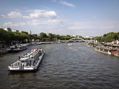 A touristic boat navigates on the River Seine in Paris.