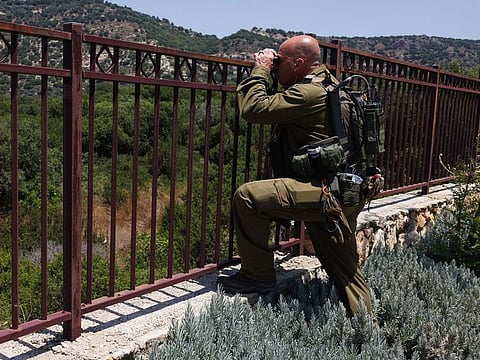 An Israeli soldier keeps a lookout towards the Lebanon border in the deserted Kibbutz Eilon, northern Israel. Hezbollah has fired missiles, mortars, rockets and explosive drones into northern Israel almost daily, prompting Israel to respond with its own fire. Photographer: Kobi Wolf/Bloomberg