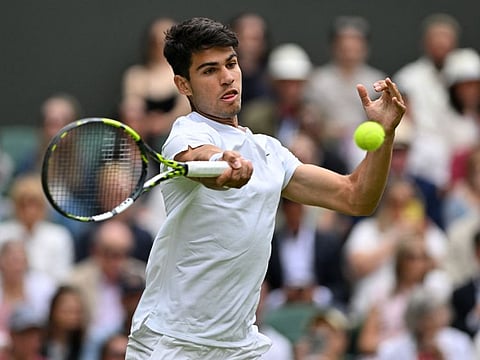 Spain's Carlos Alcaraz returns against Estonia's Mark Lajal during their men's singles tennis match on the first day of the 2024 Wimbledon Championships at The All England Lawn Tennis and Croquet Club in Wimbledon, southwest London, on Monday.