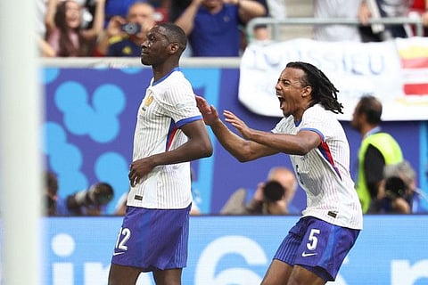France's forward Randal Kolo Muani (left) and defender Jules Kounde celebrate their team's first goal during the Uefa Euro 2024 round of 16 football match at the Duesseldorf Arena on Monday.