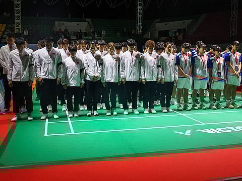 Chinese badminton players and coaches (in white jackets and black armbands), along with all players competing in the 2024 Asia Junior Championship, praying together for the late Chinese player Zhang Zhi Jie, who collapsed during a match against Japan in the preliminary round and received medical assistance in Yogyakarta.