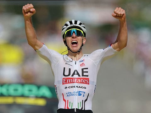 UAE Team Emirates team's Slovenian rider Tadej Pogacar cycles to the finish line to win the 4th stage of the 111th edition of the Tour de France cycling race on Tuesday.