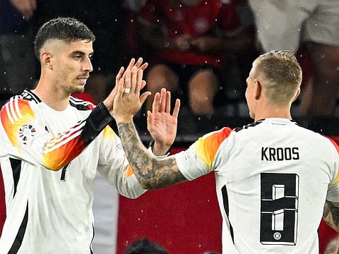 Germany's forward Kai Havertz celebrates with teammate Toni Kroos after scoring his team's first goal from the penalty spot during the Uefa Euro 2024 round of 16 football match against Denmark at the BVB Stadion Dortmund in Dortmund on June 29.