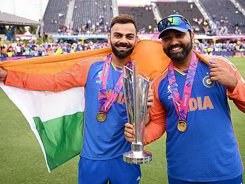 India’s captain Rohit Sharma (right) and Virat Kohli pose with the T20 World Cup in Barbados on June 29, 2024.