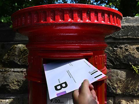 An envelope containing a Postal Vote for the upcoming UK General Election is posted in Birkenhead, north west England.