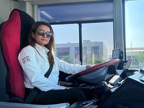 Shanti Kumari Bhandari behind the wheels of the double decker bus that she plies in Dubai.