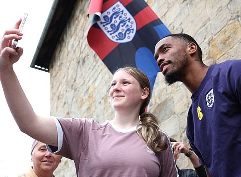 England's forward Ivan Toney holds poses for a selfie with a supporter after a press conference at the team's base camp, the Weimarer Land golf resort, near Blankenhain, on Wednesday.