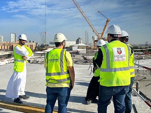 Municipality inspectors at a construction site in Abu Dhabi recently. The midday work ban lasts from June 15 to September 15.
