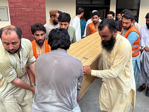 People carry the coffin of former senator Hidayatullah Khan to an ambulance after he was killed in a bomb explosion at Bajaur district of Pakistan's Khyber Pakhtunkhwa province last year. Similar attacks have increased in Pakistan since the Taliban authorities returned to power in Afghanistan in August 2021.